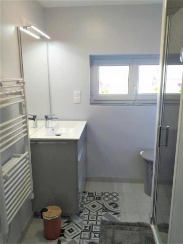 a white bathroom with a sink and a shower at Gîte G4144 in Saint-Pierre-de-Varengeville
