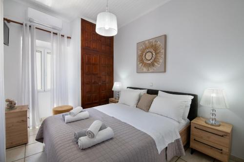 a bedroom with a large bed with towels on it at Paxos Center in Gaios