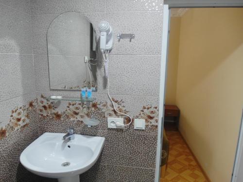 a bathroom with a shower with a sink and a mirror at Mestia 4 season in Mestia