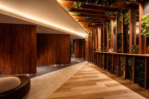 a hallway with wood paneling and plants at The ISA Hotel Tenjin Fukuoka in Fukuoka