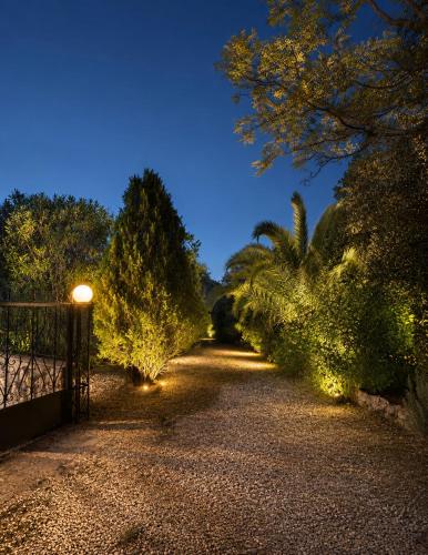 a pathway with trees and a street light at night at Villa Marlene in Astris