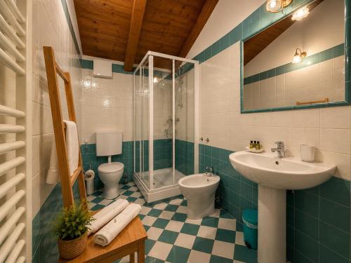 a bathroom with a sink and a shower and a toilet at Aurisina residence in Aurisina