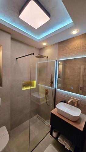 a bathroom with a glass shower and a sink at Villa Principessa Podstrana in Podstrana
