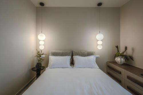 a bedroom with a large white bed with two pillows at Akari - Luxury Apartment in Preveza