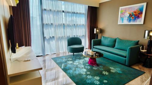 a living room with a couch and a table at Imperial KLCC Residences in Kuala Lumpur