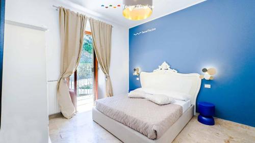 a blue bedroom with a bed and a window at Terre Marine Rooms in Riomaggiore