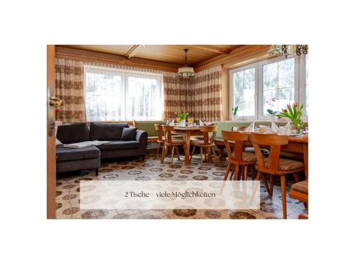 a living room with a table and chairs at Ferienhaus Alpenblick, ganzes Ferienhaus, 5 Zi, 4 Bäder, gratis Parkplatz, Sonnenterrasse in Heiligenblut