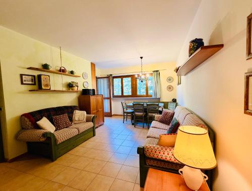 a living room with two couches and a dining room at Dolomites Soundscape - Birds River Snow Ski Bus Bike Hike in Alleghe