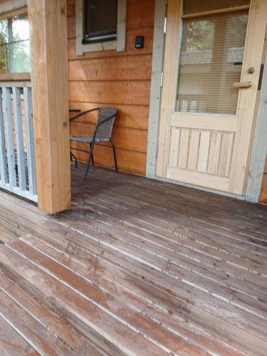 a porch of a house with a chair on it at Villa Polly, Jaala, Luxury cottage with private sauna in Kouvola