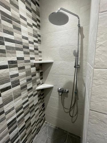 a bathroom with a shower with a glass door at Avra Port House in Porto Heli