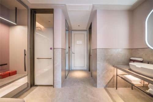 a bathroom with a sink and a mirror at Mercure Changbai Mountain North in Antu