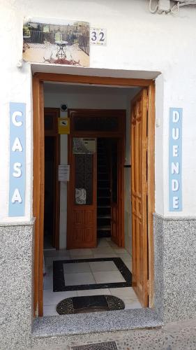 an entrance to a building with a door and a sign at Casa Duende del Tajo in Ronda