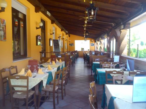 a restaurant with tables and chairs in a room at Casa Vacanza Holiday in Pieris
