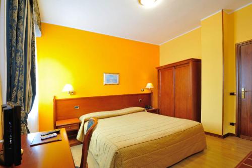 Postel nebo postele na pokoji v ubytování Hotel Il Vigneto