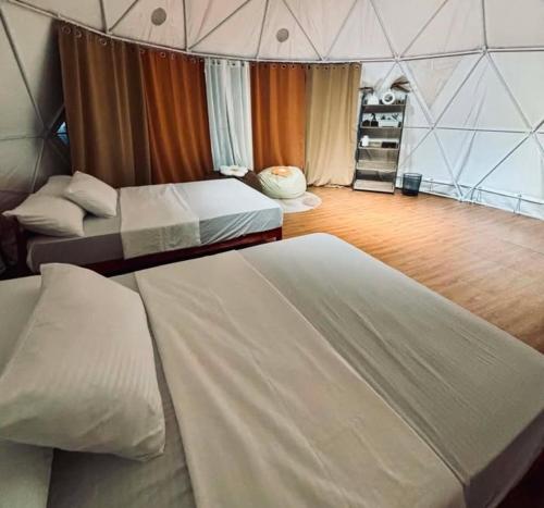 a room with two beds in a tent at CAELO | Peaceful Mountain View Rive in Pililla