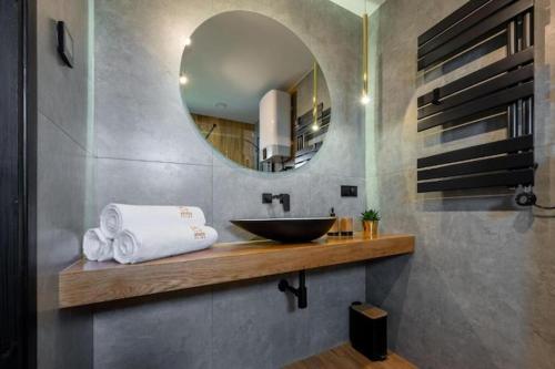 a bathroom with a sink and a mirror at Comfortable holiday home, pool, sauna, jacuzzi in Kopań