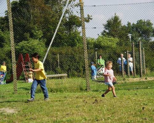 two young boys playing baseball in a park at Friesenhof in Friedrichskoog