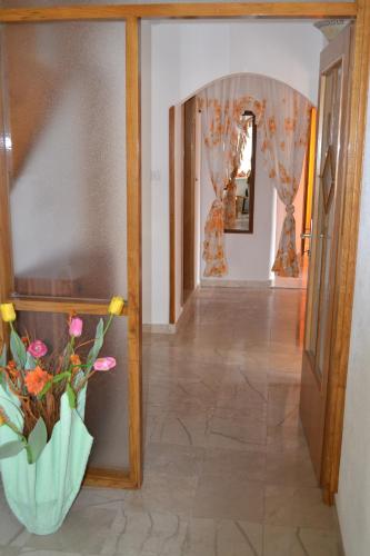 a hallway with a vase of flowers on a wall at Apartment Topic in Baška Voda