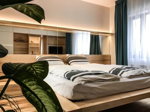 a bedroom with a large bed with a large mirror at Garden House in Timişoara
