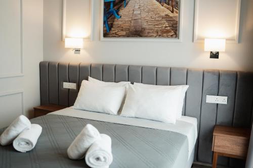 a bedroom with a bed with towels on it at Archontiko Kiverniti in Pano Lefkara