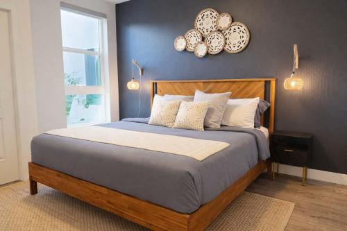 a bedroom with a bed and a clock on the wall at Artistic Getaway 10 Min to Disneyland With Pool&GYM in Tustin