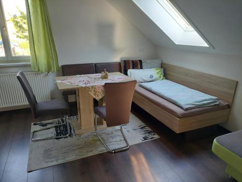 a room with a bed and a table and a couch at Ferienhaus Erika in Voitsberg