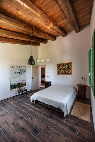 a bedroom with a bed and a wooden ceiling at All'ombra della quercia in Fano