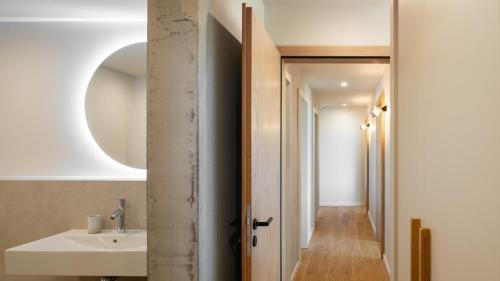 a bathroom with a sink and a mirror at Chalet DU MERLE - CHAMP DU FEU - NEUF 5 ETOILES in Belmont