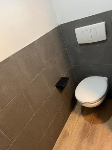 a bathroom with a white toilet in a room at Vakantiebungalow Maison7 in Plombières
