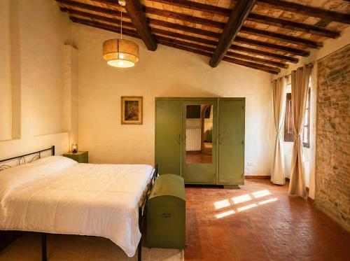 a bedroom with a large bed in a room at Tenuta di Valmarino - Adults only in Corciano