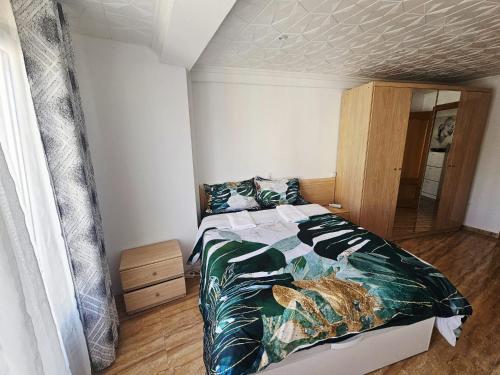 a bedroom with a bed with a fish comforter at MarDeSantaPola in Santa Pola