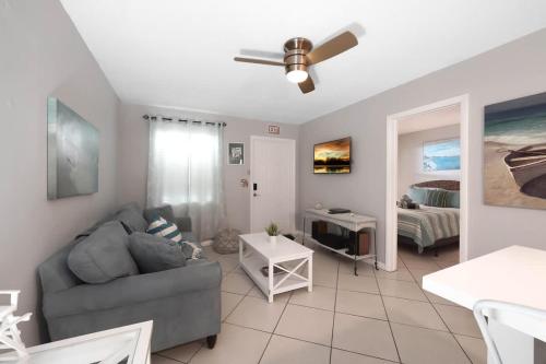 a living room with a couch and a ceiling fan at Beach Apart by Dream Vacation unit 3 in West Palm Beach