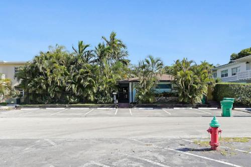 a red and green fire hydrant in a parking lot at Beach Apart by Dream Vacation unit 3 in West Palm Beach