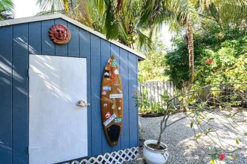 a surfboard is sticking out of a blue shed at Peacock Villa 2 by Dream Vacation in Fort Lauderdale