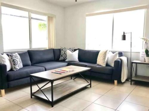 a living room with a blue couch and a coffee table at The peacock villa 1 by Dream Vacation in Fort Lauderdale