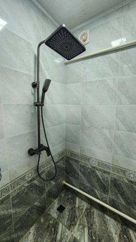 a shower with a shower head in a bathroom at Keremet Yurt in Bokonbayevo