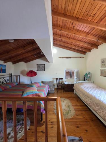 a living room with two beds and a table at Sidirounda Traditional House 1 in Sidiroúnta