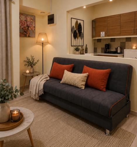 a living room with a blue couch and a kitchen at Casa Polyxeni -Elegant Stay in Vathi in Samos