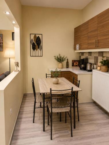a kitchen and dining room with a table and chairs at Casa Polyxeni -Elegant Stay in Vathi in Samos