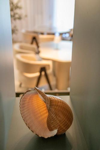a shell sitting on a table in front of a desk at Rezydencja Familia in Świnoujście