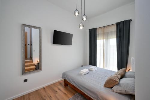 a bedroom with a bed and a mirror at 4 bedroom home Sigma in Zlatar