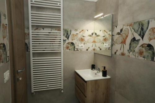 a bathroom with a sink and a mirror at La Rosa di Antonio & Relax Room in Tricase