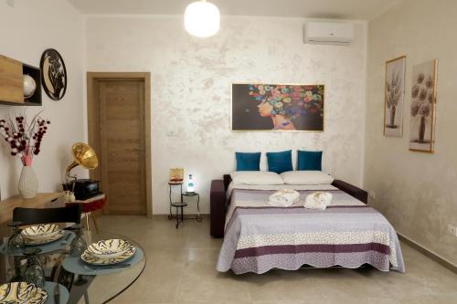 a bedroom with a bed with blue pillows at La Rosa di Antonio & Relax Room in Tricase
