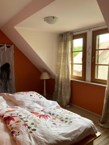 a bedroom with a bed and a window at Ferienwohnung Haubitz in Borna