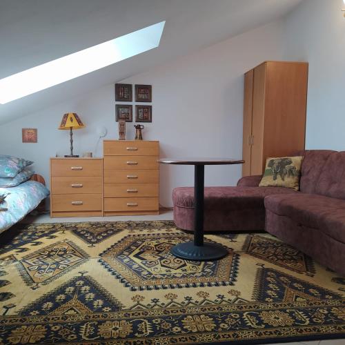 a living room with a couch and a table at Złota Rybka in Rowy