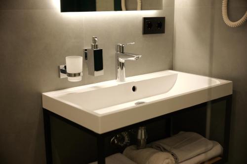 a bathroom with a white sink and a mirror at BVS Hotel in Ukrayinka