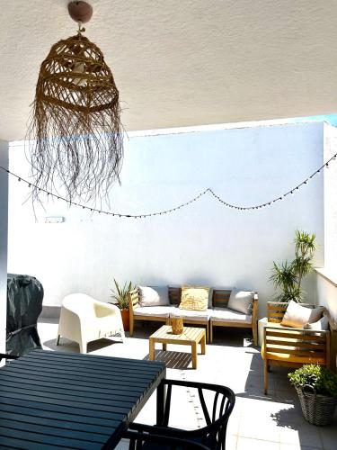 a patio with a couch and a table and chairs at Casa Calafat in Calafat