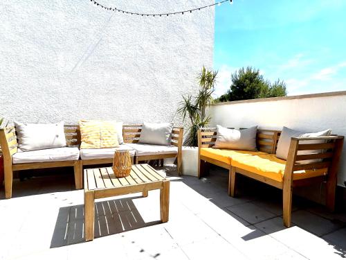 a patio with couches and a table and chairs at Casa Calafat in Calafat
