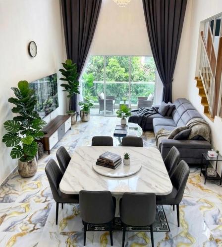 a living room with a table and a couch at Skyn Heaven Penthouse in Tanah Rata