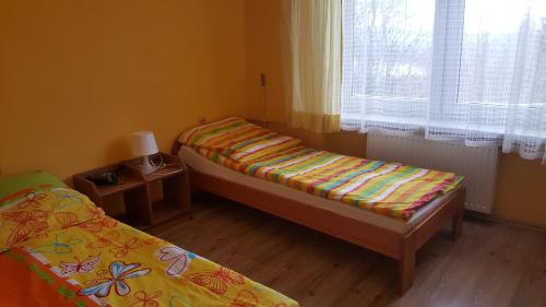 a small room with two beds and a window at Dom wczasowy Lubuszanin in Podgórzyn
